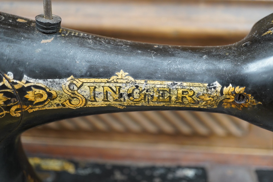 An early 20th century cased Singer sewing machine, 46cm wide at base. Condition - poor